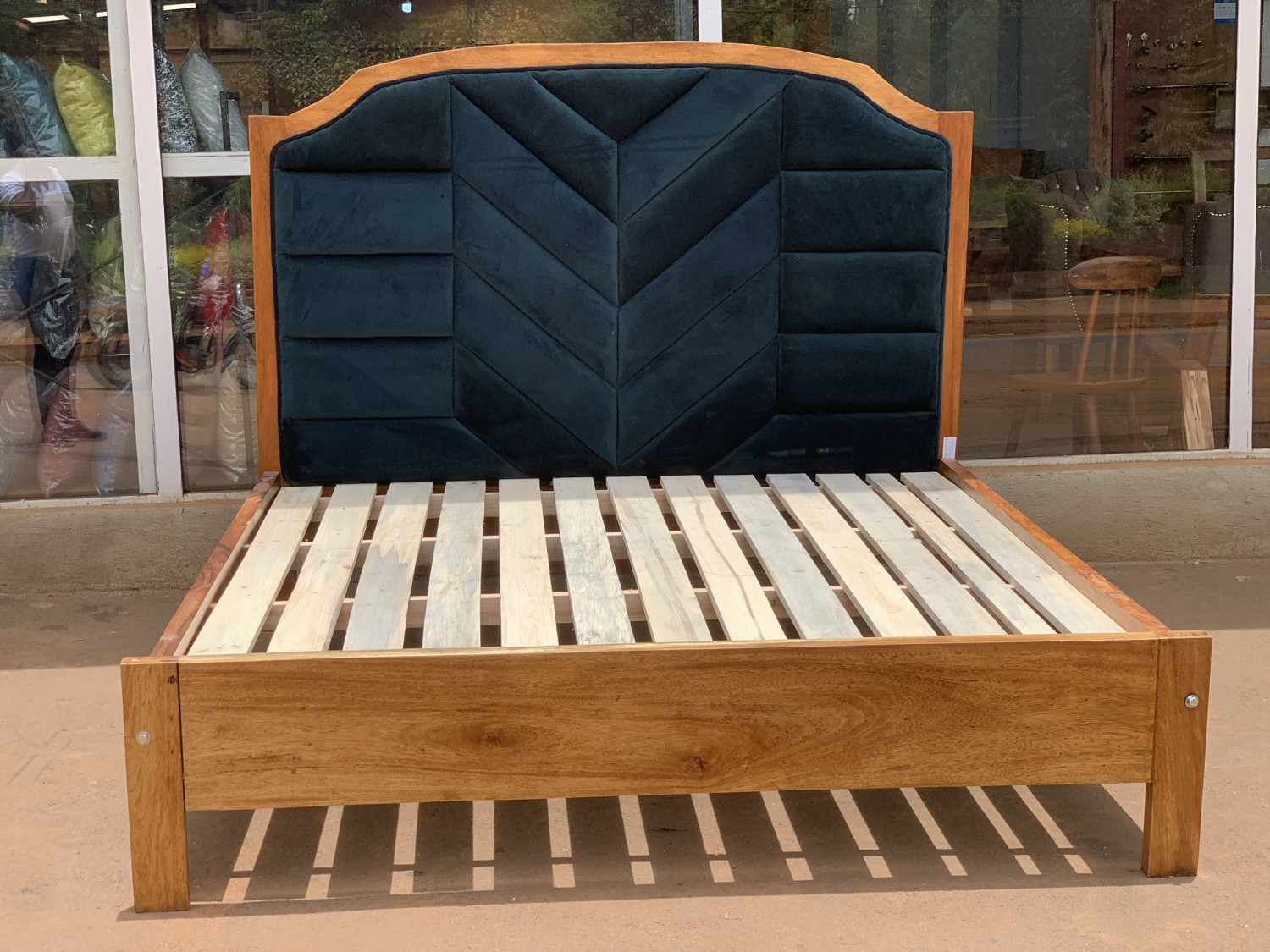 Upholstered bed gives a sophisticated, yet soft feel to a bedroom with a fabric covered headboard.